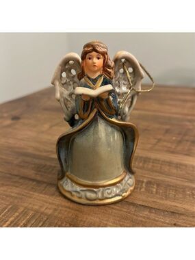 Ceramic Angel Bell. Gold cord attached to the wing, to use as Christmas ornament